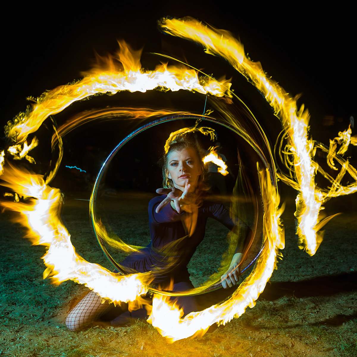 apple valley woman kneeling on ground with fire effect united states